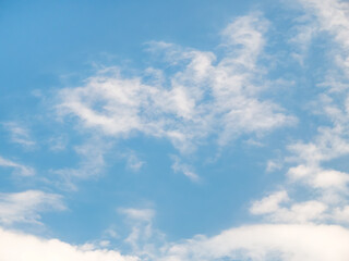White clouds on a blue sky background.