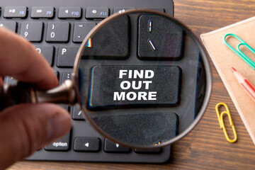 FIND OUT MORE. Computer keyboard on a wooden table