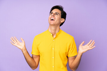 Man over isolated purple background smiling a lot