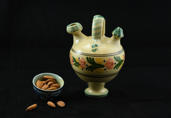 ceramic pot with bowl of almonds