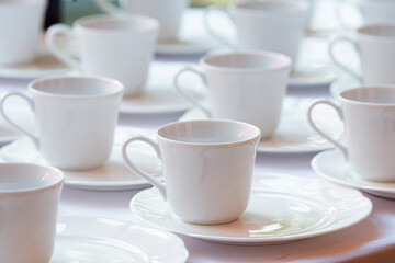 Group of empty cups in many rows of a white cup for coffee in breakfast and seminar event.