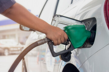 Close up of fuel monitoring system refueling a petroleum to vehicle at gas station.