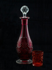 red glass bottle with glass