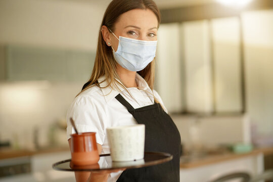 Portrait Of Waitress Wearing Face Mask At Work