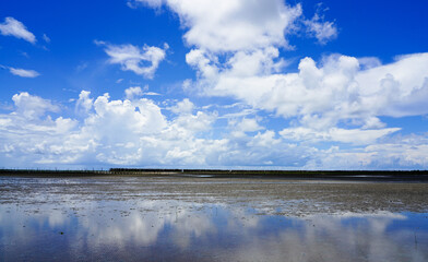 Blue sky with clouds reflection on clear water at Thailand mangrove forest Rayong