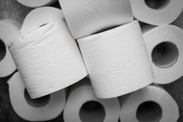 Buying many rolls of toilet paper for fear of spreading coronavirus infection. Toilet paper on the background of an article, banner or advertisement.