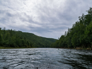 mountain river hills Northern forest and sky kayak