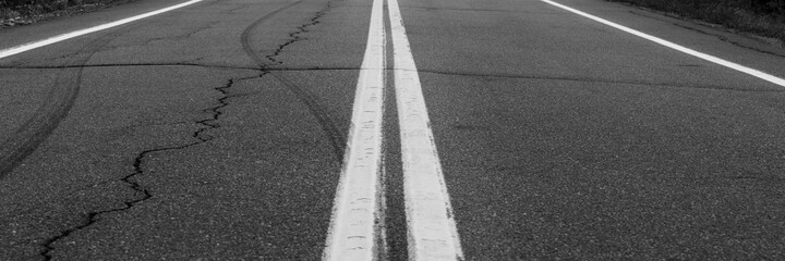 Asphalt background with two white road lines. Road markings on asphalt