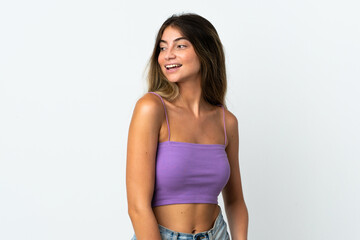 Naklejka premium Young caucasian woman isolated on white background looking to the side and smiling