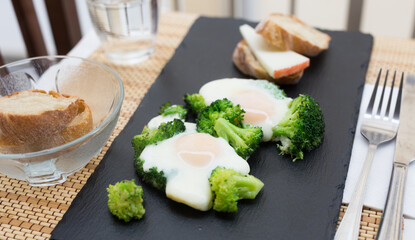breakfast of crumpled eggs with broccoli