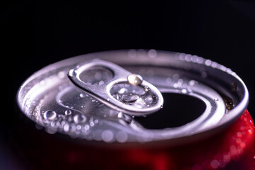 Open aluminum can with water drops or dew close-up macro shot, top view