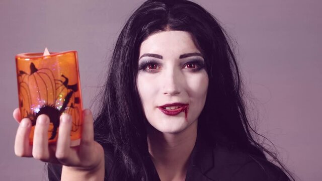 Young woman with halloween makeup doing shhhh
