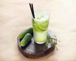 cucumber lemonade on a wooden stand in a glass glass