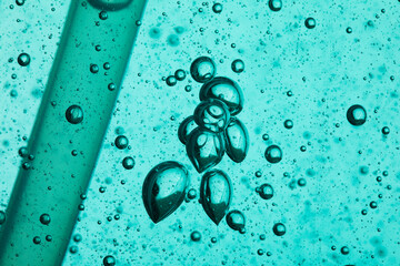 Transparent gel with air bubbles, macro shot. Close up of clear blue liquid soap, cosmetic cream...