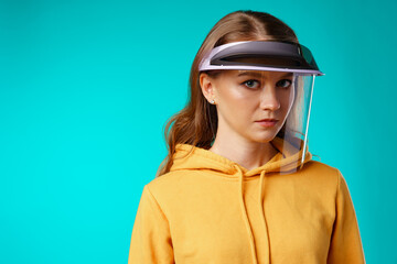 Young woman wearing medical protective face shield