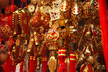 Close up of Chinese lucky charms for good luck, Red knotted ornaments and Gold coins, fish and lantern, Concept image for Chinese festival and new year souvenir.  