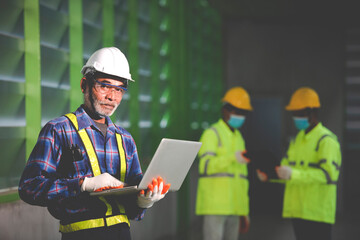 The construction supervisor inspects the warehouse at the workplace with the team