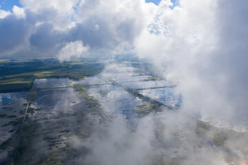 Aerial view of flooded Seda swamp (Sedas purvs) water lakes and clouds