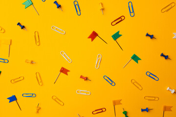 Color push pins pattern on yellow background