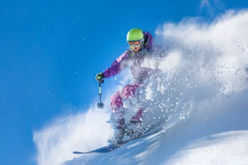 Fotobehang Girl skiing through the fresh snow © Marcin