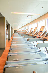 Staying fit with cardio fitness equipment and treadmills in gym or fitness center on modern...