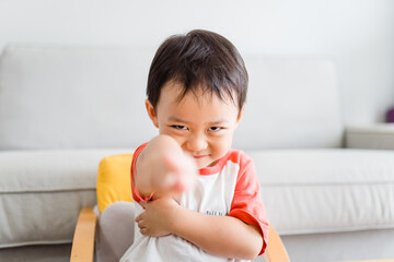 Fototapeta premium Angry kid.Little asian boy looking at his mother and fighting with mom.Furious hungry toddler kid got upset and sad and he has a negative attitude.Depressed little toddler boy complaining.Ef in Kid.