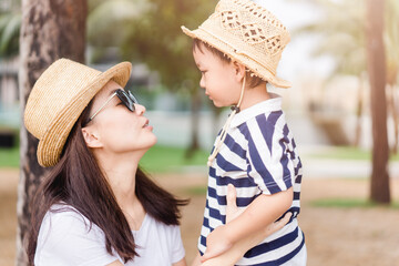 Happy loving family.Asian mother and baby boy child talking in playground outdoor at the park.Cute child with mother encourage and play.Child development,Mother and son traveller, Healthcare, People.