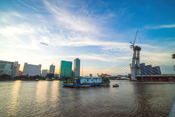Fototapeta premium Bitexco Financial Tower building, buildings, roads, Thu Thiem 2 bridge and Saigon river in Ho Chi Minh city - This city is a popular tourist destination of Vietnam.