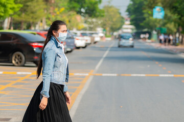 Asian woman wearing protective mask against covid19 transmissible infectious diseases and as protection against pollution.