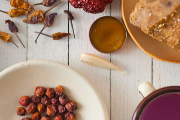 Spices and herbs on white wood table