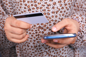  women hand holding credit card and using smart phone shopping online 