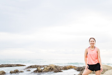 Running asian woman at the beach in the morning.Female runner jogging during outdoor workout on beach. Beautiful fit asian fitness model outdoors.Healthy lifestyle, Portrait people fitness aerobic.