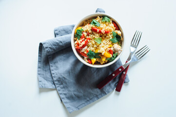 healthy lunch bowl with bulgur, chicken, sweet peppers, onion and parsley