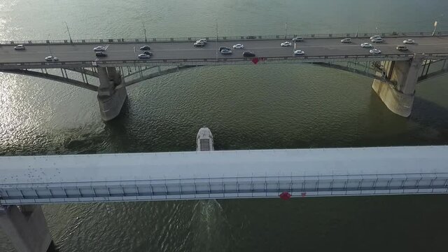 a flying camera chases a passenger boat on the ob river in siberia