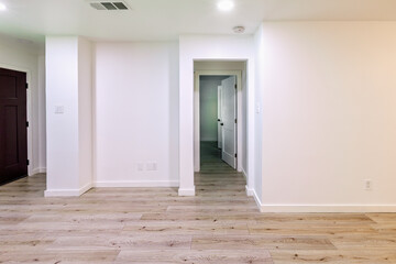 Empty living room with white walls and hardwood floor