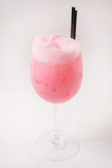 Pink cocktail with frothed cream.