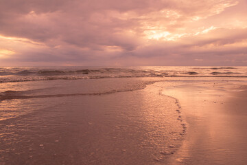 Fototapeta na wymiar Beautiful waves on the beach with in sunrise.