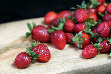 Strawberry. Big red ripe juicy berry, on a black background.
