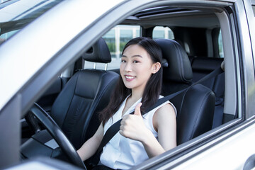 Fototapeta na wymiar woman hand fastening a seat belt in the car