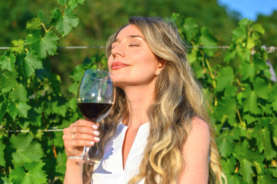 Woman Smelling Wine Aroma Taste. Happy Girl Drinking Wine. Beauty Lady With A Glass Of Wine Dreamy Looks