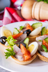 delicious snack tartlets on dark stone background