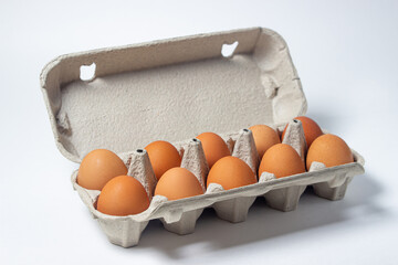 Eggs on a white background. Chicken eggs in a paper box