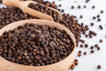 fragrant black pepper on white acrylic background