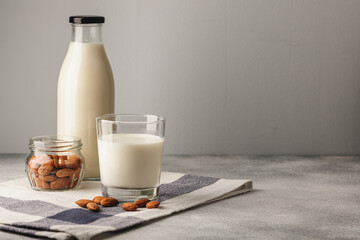 Almond milk with almond nuts in glass