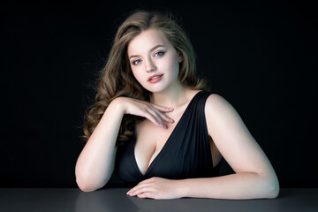 Fototapeta premium Young beautiful woman with natural makeup on black background. Beauty & Skin care concept. Plus size model.