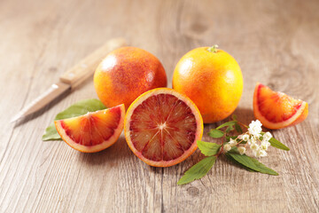 red blood orange and leaf on wood background