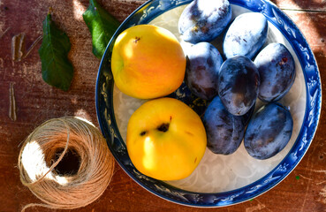 Fresh organic plums and yellow apples on wooden background. cooking organic dessert 