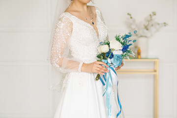 Decoration on the bride in a white dress with bouquet