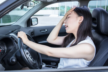 Obraz na płótnie Canvas Depressed woman driver sitting in her car, feeling emotional burnout after work. Chronic fatigue