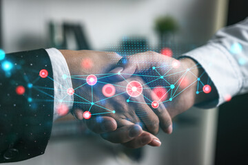 Double exposure of two businesspeople handshake and abstract technology hologram drawing...